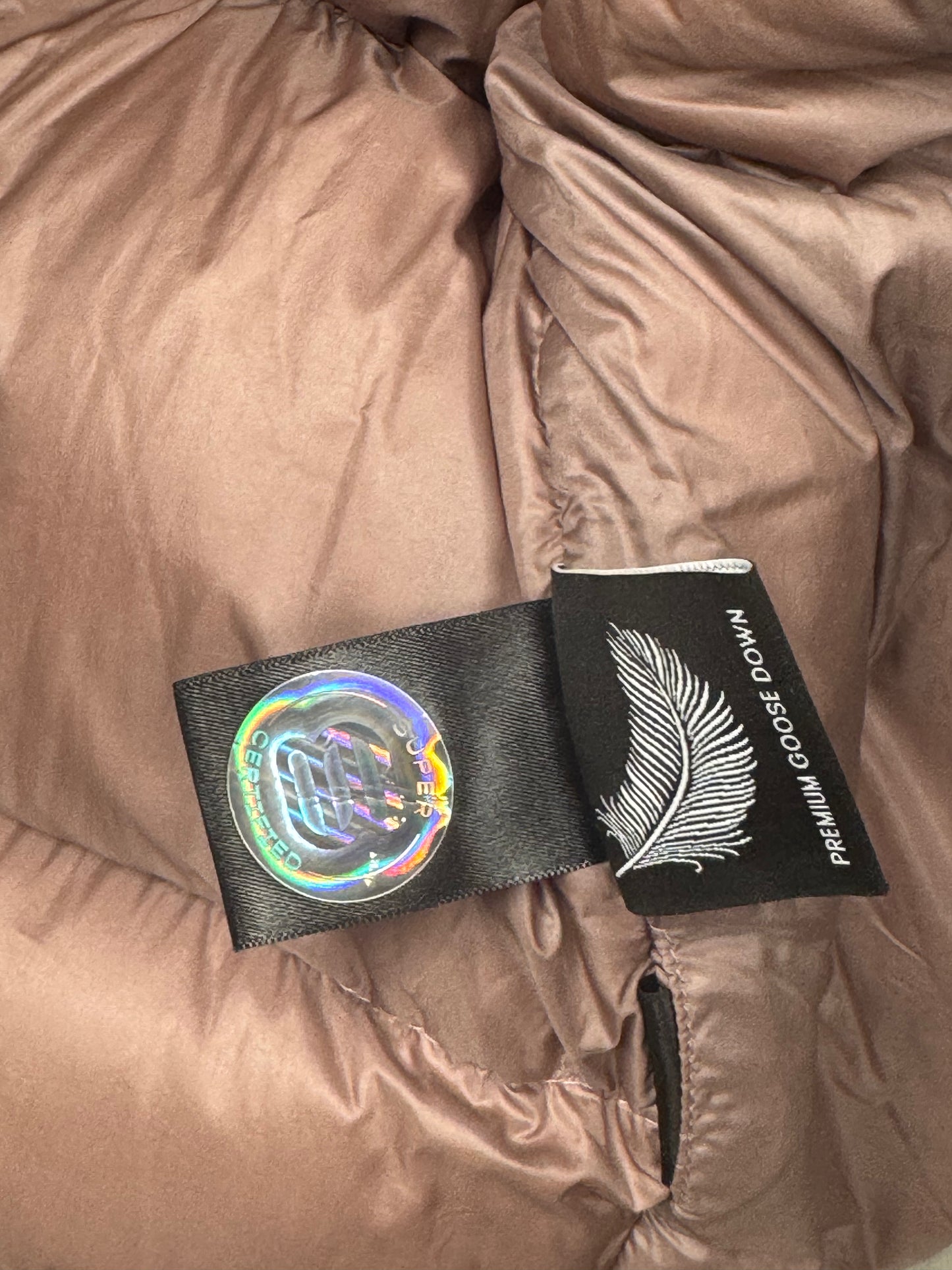 Trend: Liquid Shine 700+ Fill “Super Puff” Coat in Iridescent Pink