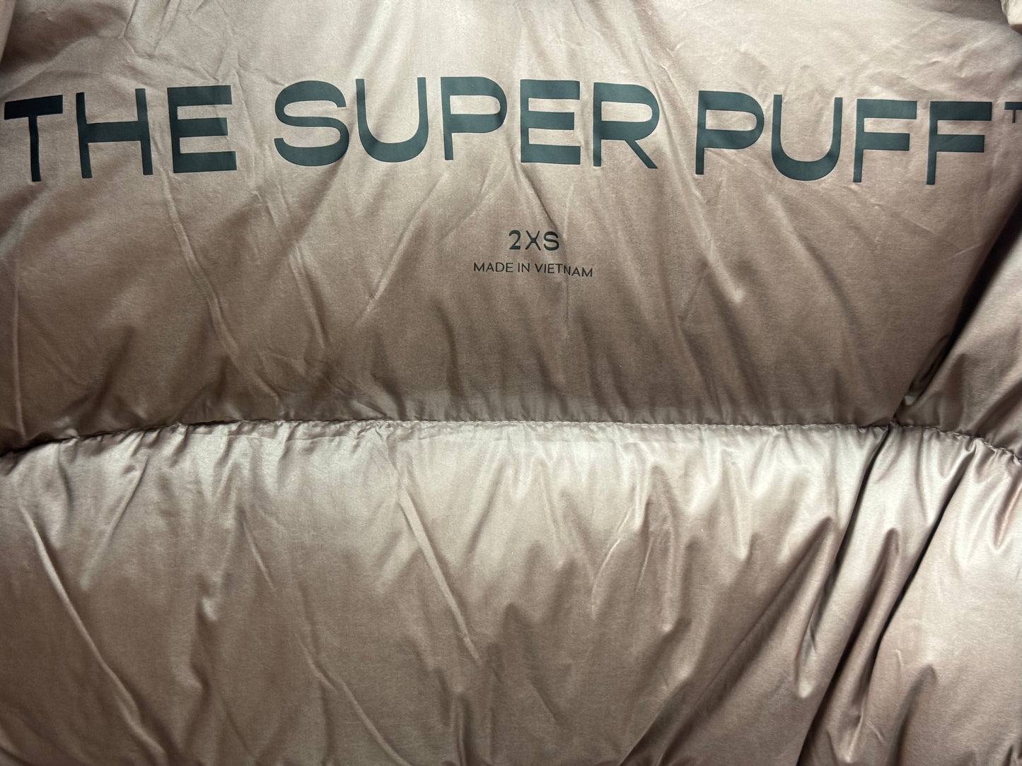 Trend: Liquid Shine 700+ Fill “Super Puff” Coat in Iridescent Pink